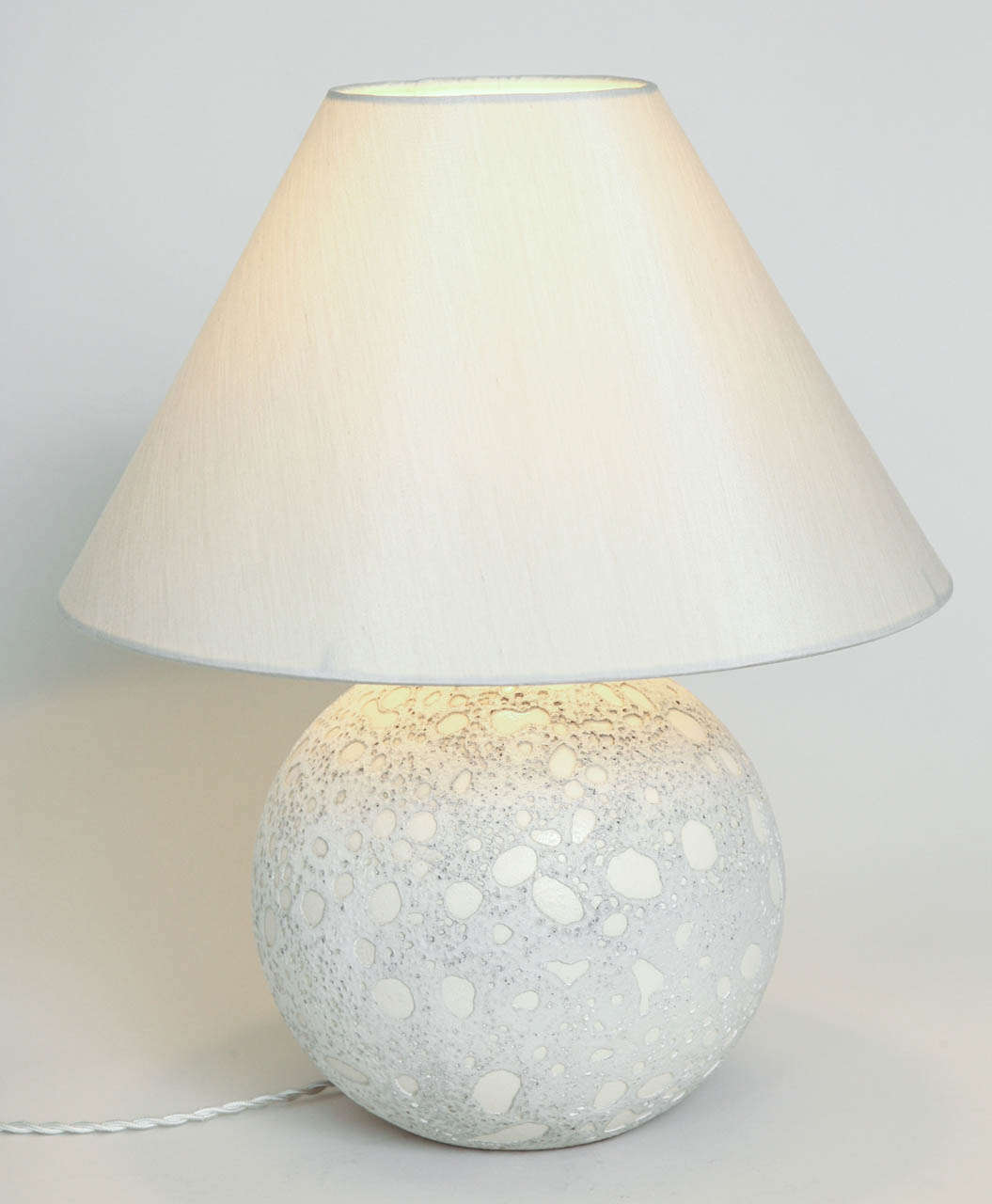 This spherical lamp base has a double lace effect with ivory enamel against a white background.
Has been rewired to U.S. standards.
Signed: 