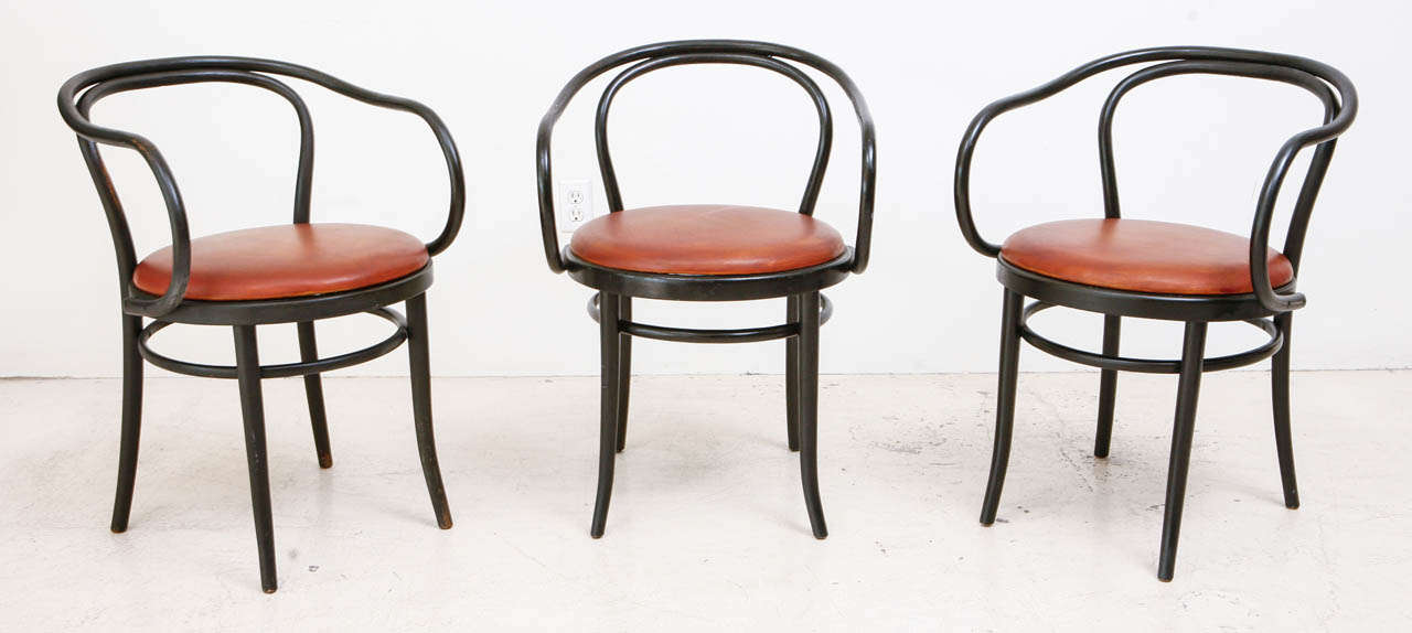 Early set of  six original Thonet arm chairs in matte black finish. With custom leather cushion seats by Jason Koharik.