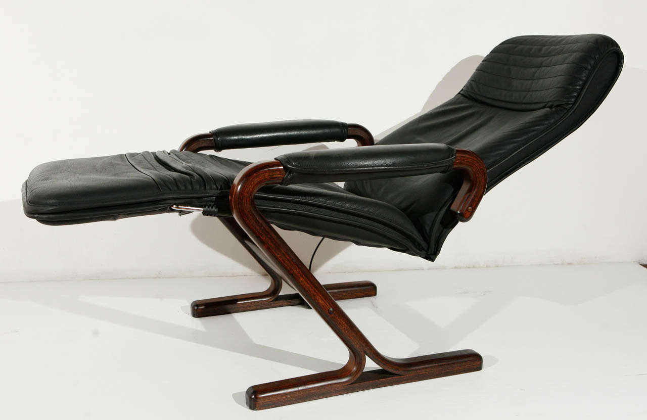 Faux leather and wood recliners; hand pump for lumbar support.