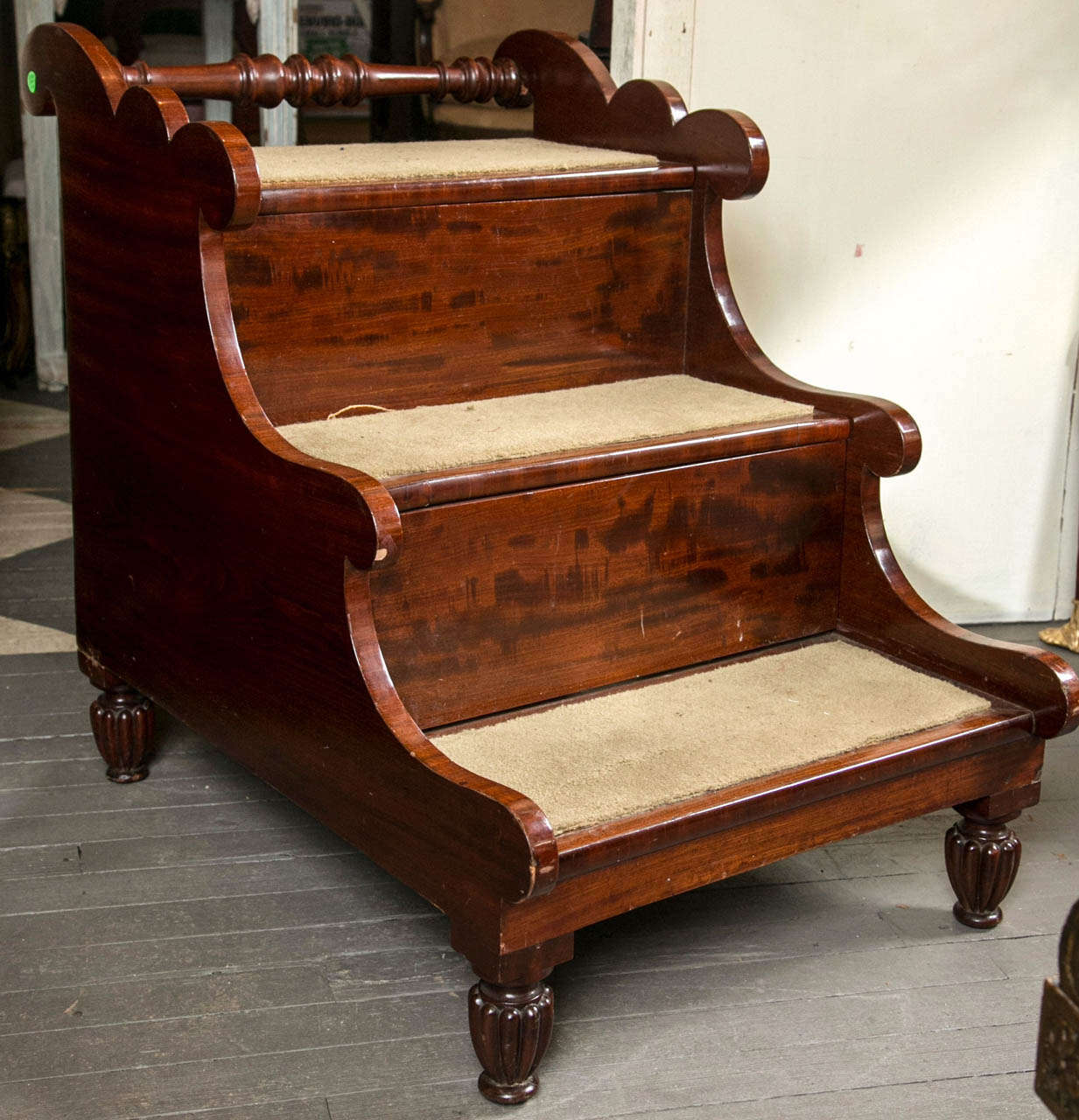 Unusual  large scale steps with  turned grab  bar at top, scalloped  side tops, sweeping down to  middle step, then sweeping to lower step.  The top step  lifts up , the middle step slides forward and lifts open to a chamber pot compartment and the