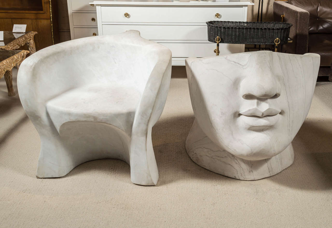 An intriguing pair of Neoclassical marble face-form, garden chairs.
In the style of Igor Mitoraj - Continental - 20th century.