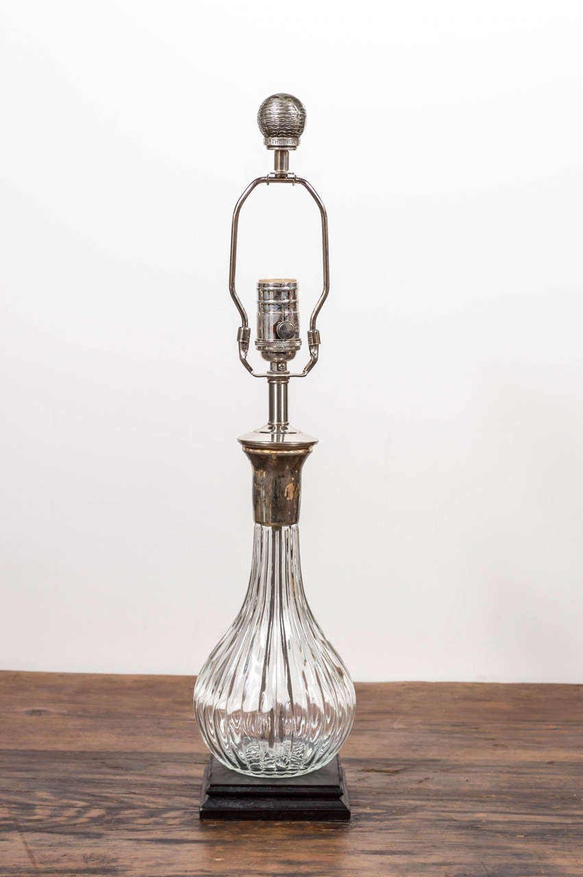 Wonderful glass and silver plate decanter mounted as lamp. Clever they were using the original stopper as a finial.
