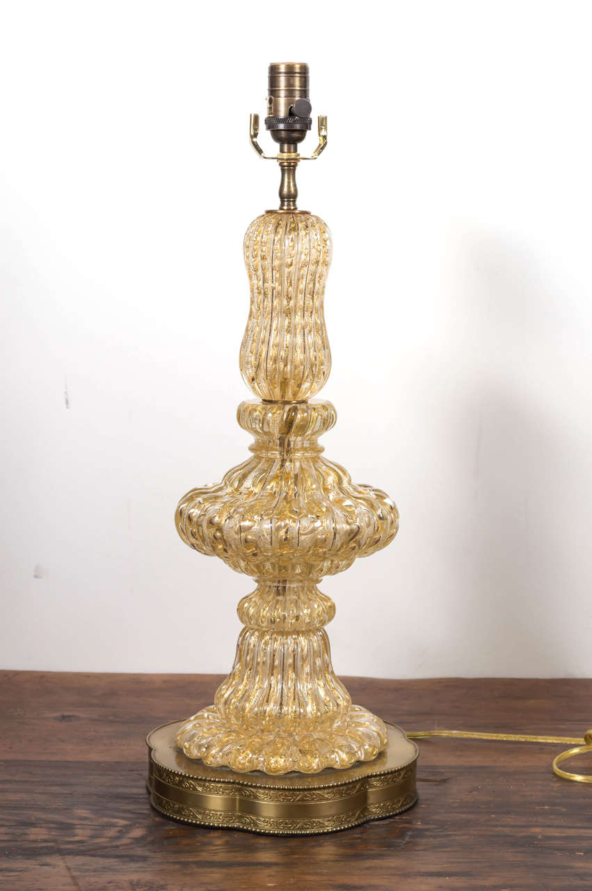 Rich spiral ribbed glass with gold flecked. Original base.