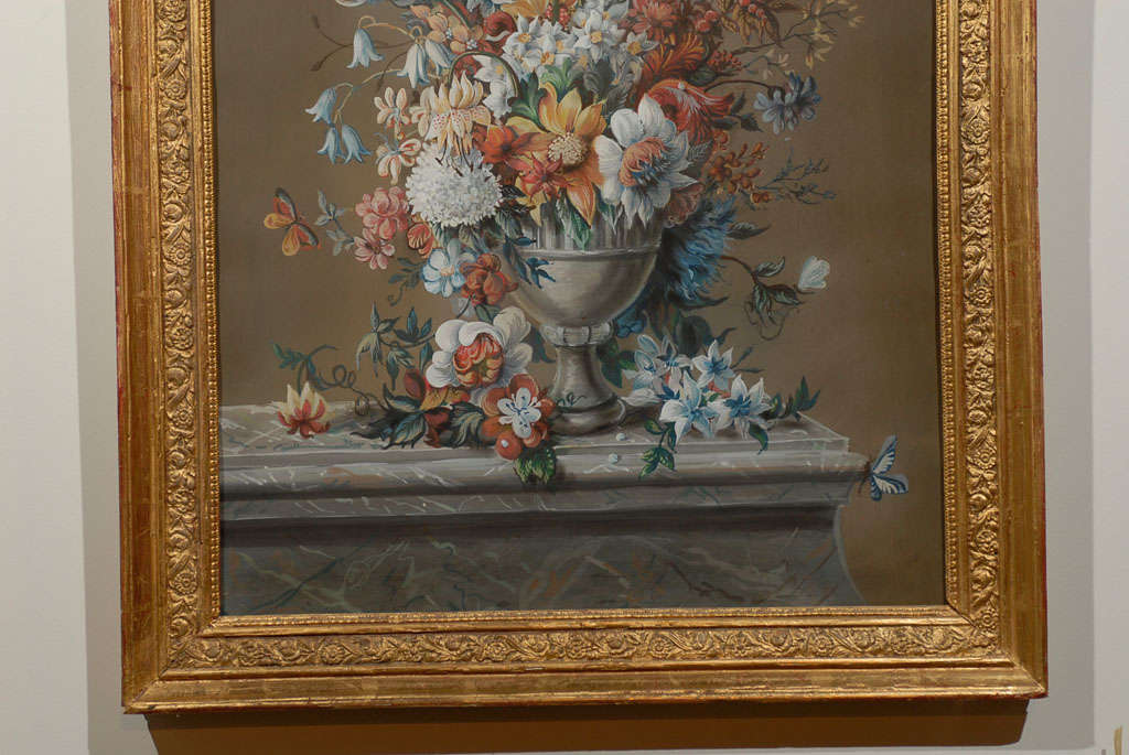 A French Empire period floral pastel and gouache painting from the early 19th century, in giltwood frame. This French painting features an exquisite depiction of a bouquet of flowers set inside a metal vase, adorned in its upper section with what