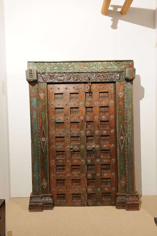 19th century haveli door with frame from Gujarat. Painted wood with iron hardmounts.
