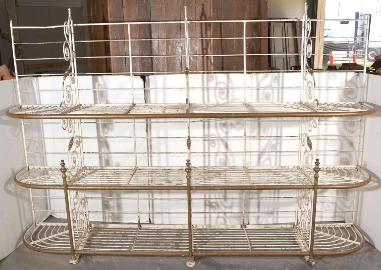 Oh so pretty French bakers rack stamped at the bottom Paris in
iron and brass painted white