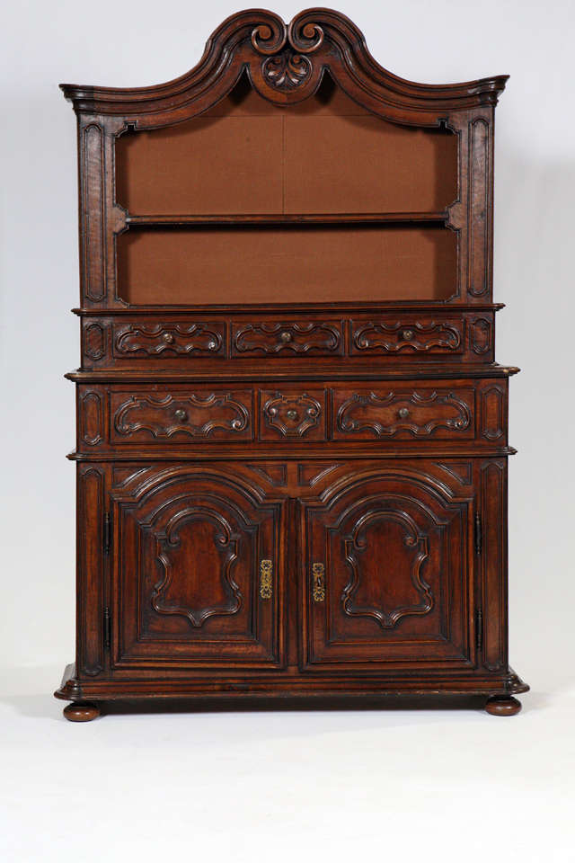 A superb Italian cabinet having two doors and three drawers in the base, with a step back section having three drawers, above the step back the wonderful arched top and display shelf. The beauty to me is the raised panel doors with elegant formation