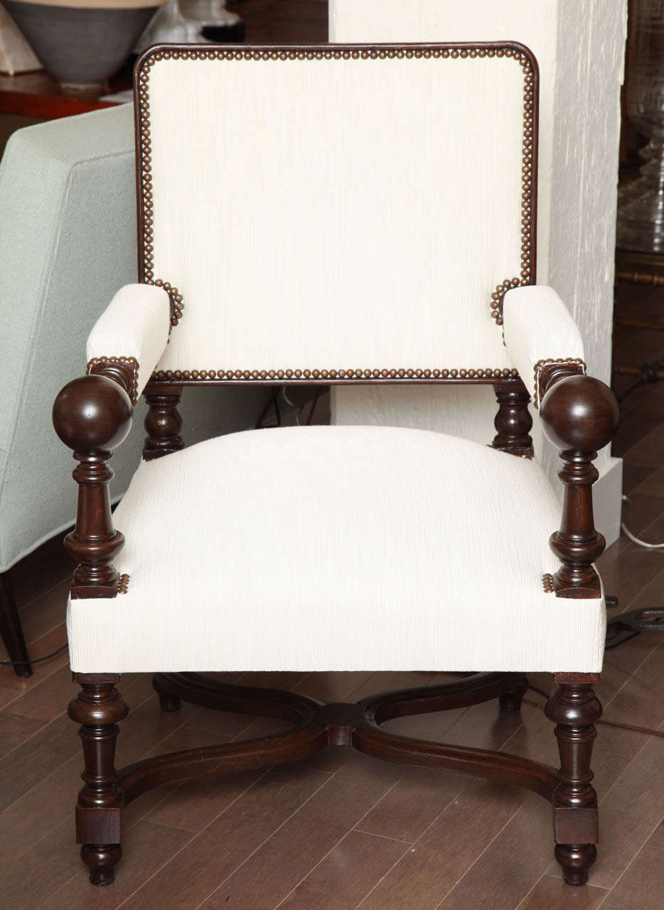 Pair of ebonized carved hall chairs in white upholstery, French 19th Century
