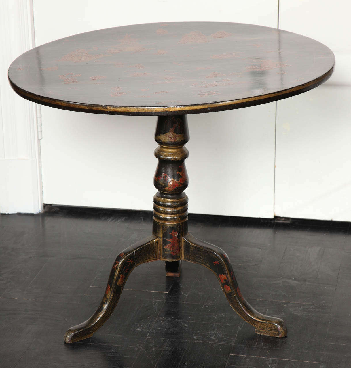 Mid-19th Century Chinese Export black chinoiserie tilt top center table with gilded pagodas, landscape, and figures, column tri-pod base similarly decorated