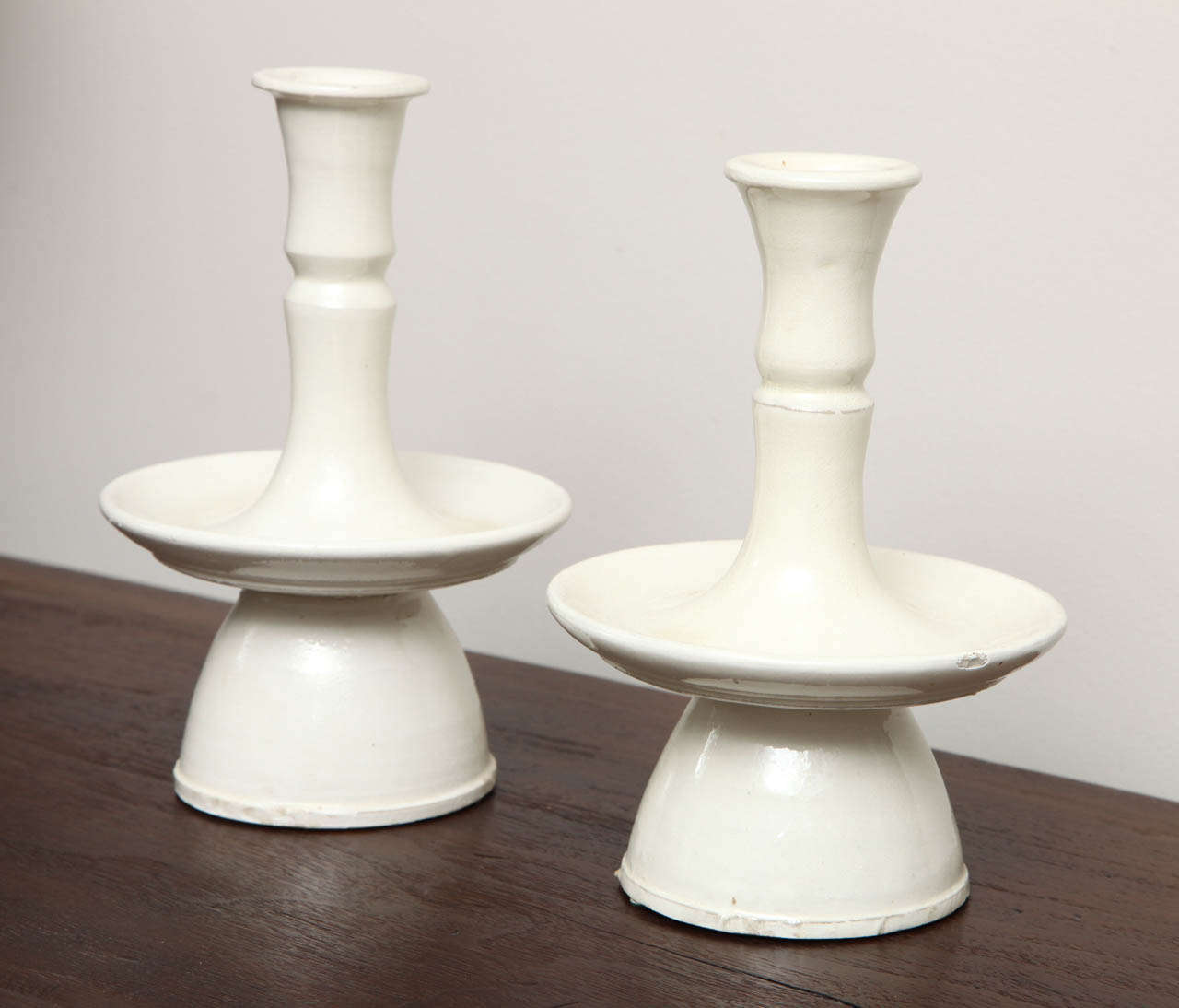Pair of Belgian white ceramic candlesticks.