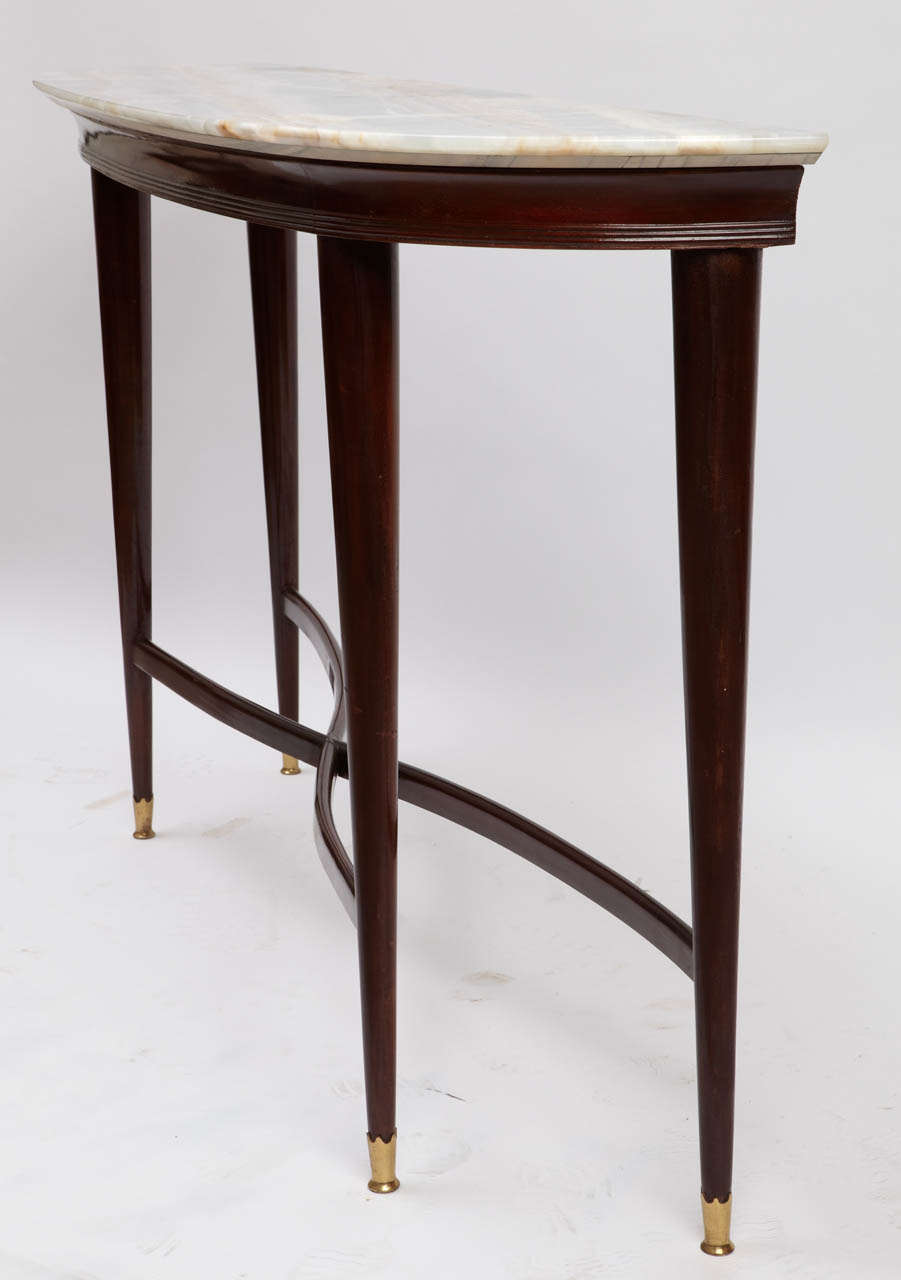 A demi lune four legs solid walnut consolle.

Golden bronze sabot at the end of the legs, onix top.