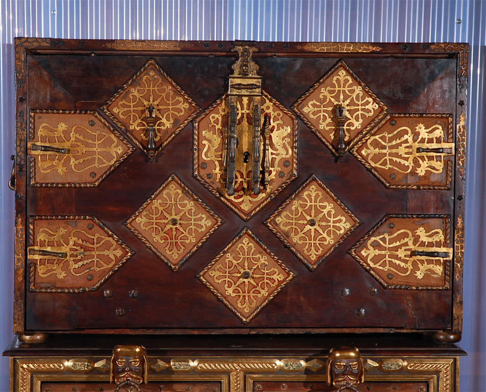 Giltwood, wrought iron, & vargueno w/fitted interior & relief.<br />
Top chest is 17th c. & bottom is 19th c.