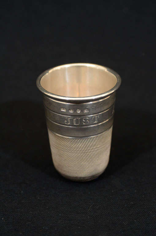 Novelty thimble-style shot cup with engraved saying 