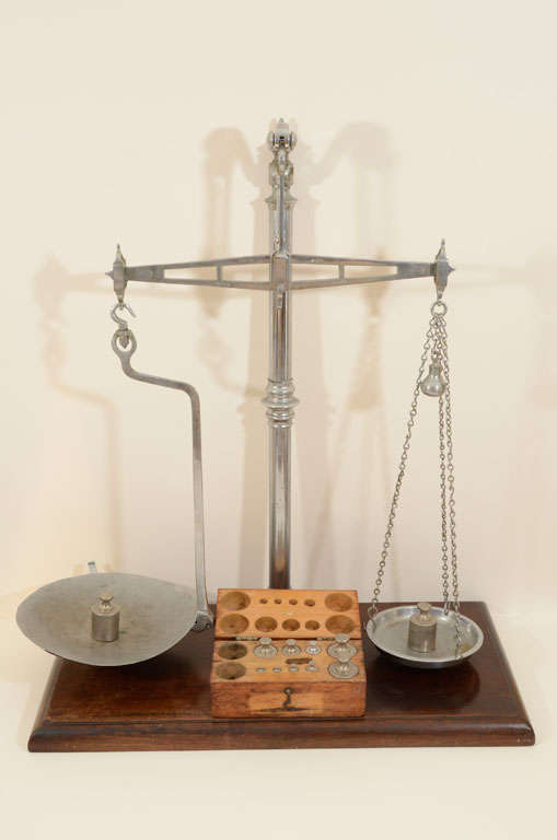 Turn of the century set of handmade scales hailing from the Buffalo, NY District Attorney's office. This equal arm scale has two pans suspended from the ends of a beam. One pan (the larger) is used for the goods to be weighed, the other for the