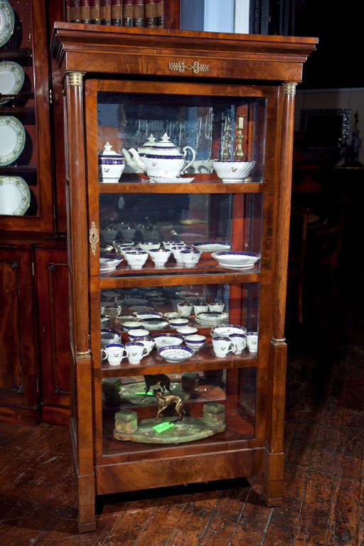 Walnut curio cabinet with bronze mounts and mirrored back. See photos.