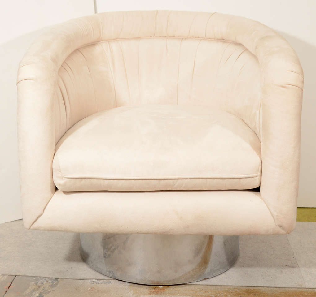 Pair of handsome tub chairs on steel clad round swivel pedestal base by Leon Rosen for Pace Collection.  These have previously been reupholstered in off-white/light beige ultra suede.