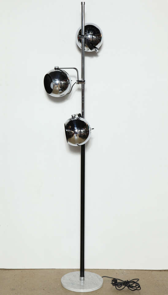 Adjustable Arteluce Triple Eyeball Chrome Globe Reading Floor Lamp. Featuring three individual, perforated and vented 7D Chrome shades, Chrome and Black enameled stem on round White Carrara Marble base. With three individual switches. Solid