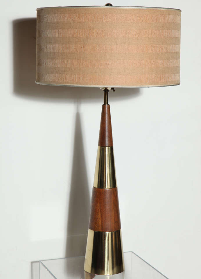 Rare, Mid-Century Modern Tall Tony Paul for Westwood rubbed solid Walnut and Brass tall Table Lamp, Circa 1958. Featuring a conical form with alternating and stScked Walnut and Brass. Three sockets. 50D vintage textured Wheat and Taupe shade is