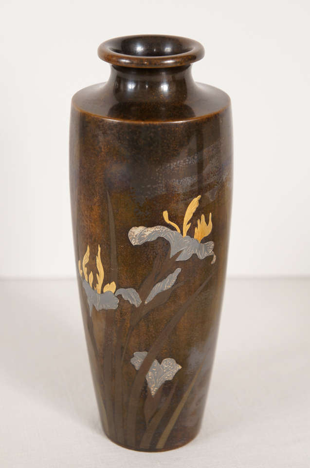 This lovely and fine pair of Japanese vases are cast in bronze and then incised and engraved and are also inlayed with silver and gold details.  Created in the very late 19th or early 20th century. The scenes are mirror images of each other and