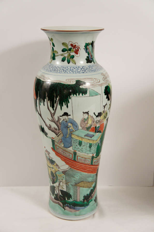 This large and impressive pair of vases done in a famille verte pallet show fine detailing and extensive painting throughout. The scenes on both are the same and depict nobles in a pavilions set within a landscape setting. The nobles are accompanied