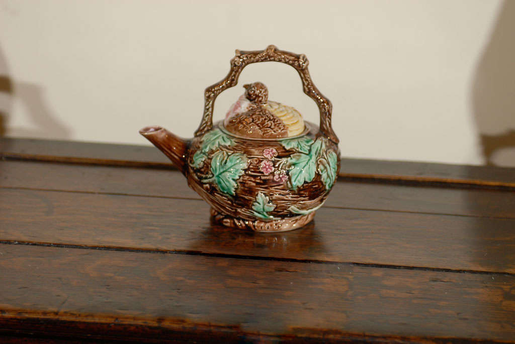 This is a fantastic example of English majolica and the whimsical themes represented.  The bird is the lid of the tea pot; the nest is the body of the pot and a delicate twig is the handle.  This is a wonderful piece.   The colors are beautiful.<br