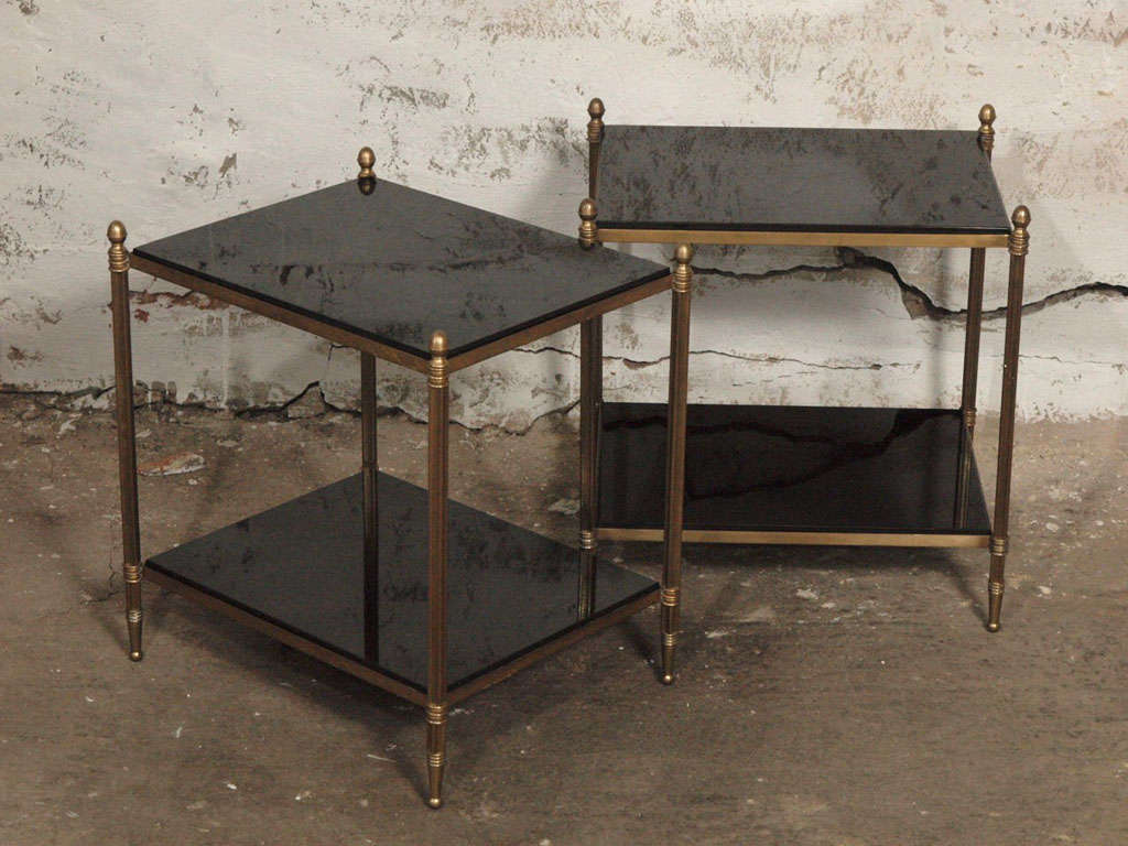 French Maison Bagues style vintage brass side tables with original black granite shelves, fluted legs, acorn finials. An elegant and timeless piece to go with any style decor, whether modern, mid century or traditional.  For a coffee or cocktail