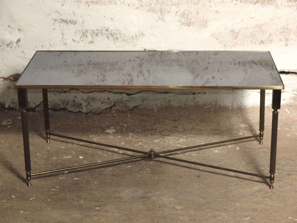 French Maison Bagues vintage rectangular brass coffee or cocktail table with original smoky grey mirror top, fluted legs, finial on X stretcher.  An elegant and timeless piece to go with any style decor, whether modern, mid century or traditional. 