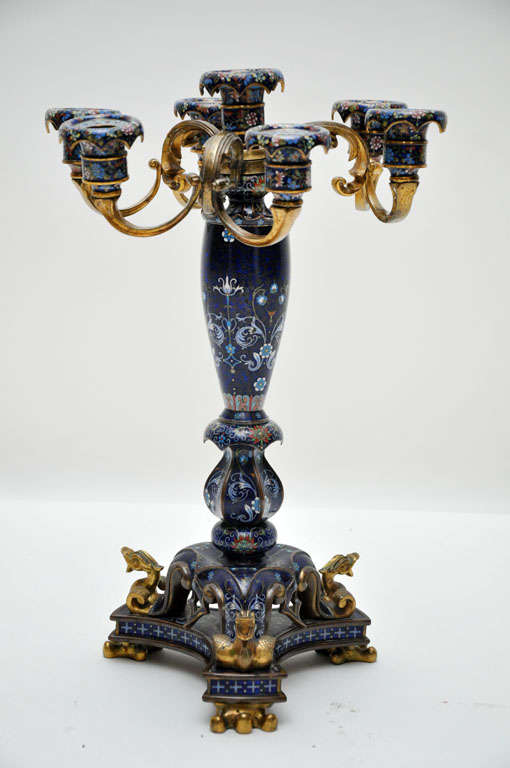 Pair of exquisite and rare cloisonné enamel gilt bronze six-light candelabras. Cobalt blue cloisonné background bulbous stemmed candlestick surrounded by six gilt bronze arms supporting cloisonné leaf molded bobaches, supported on tripod adorned