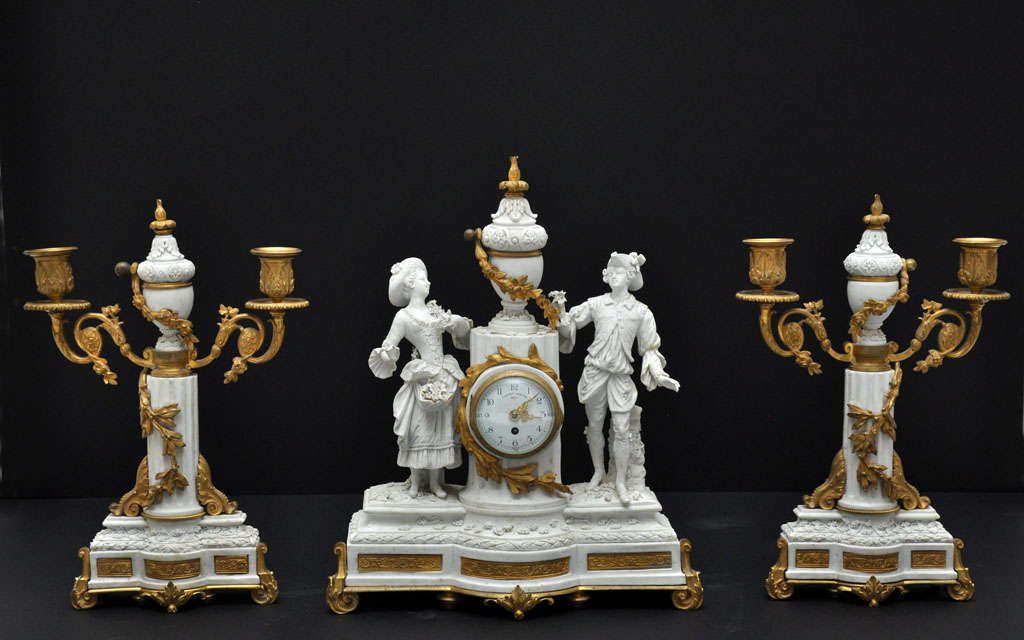 Unique French Louis XVI style Sèvres bisque porcelain and gilt bronze three-piece clock garniture. Bisque female and male sculpture in dressed in 18th century style on either side of bisque neoclassical covered urn with gilt bronze garland made of