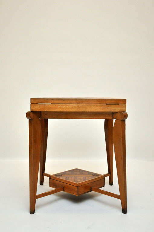 A French Art Deco oak and fruitwood envelope game / card table. Square cubed parquetry design top surface unfolds and swivels to reveal a removable marquetry International Draughts (Checkers) board, reverse side with felt surface for card playing. 