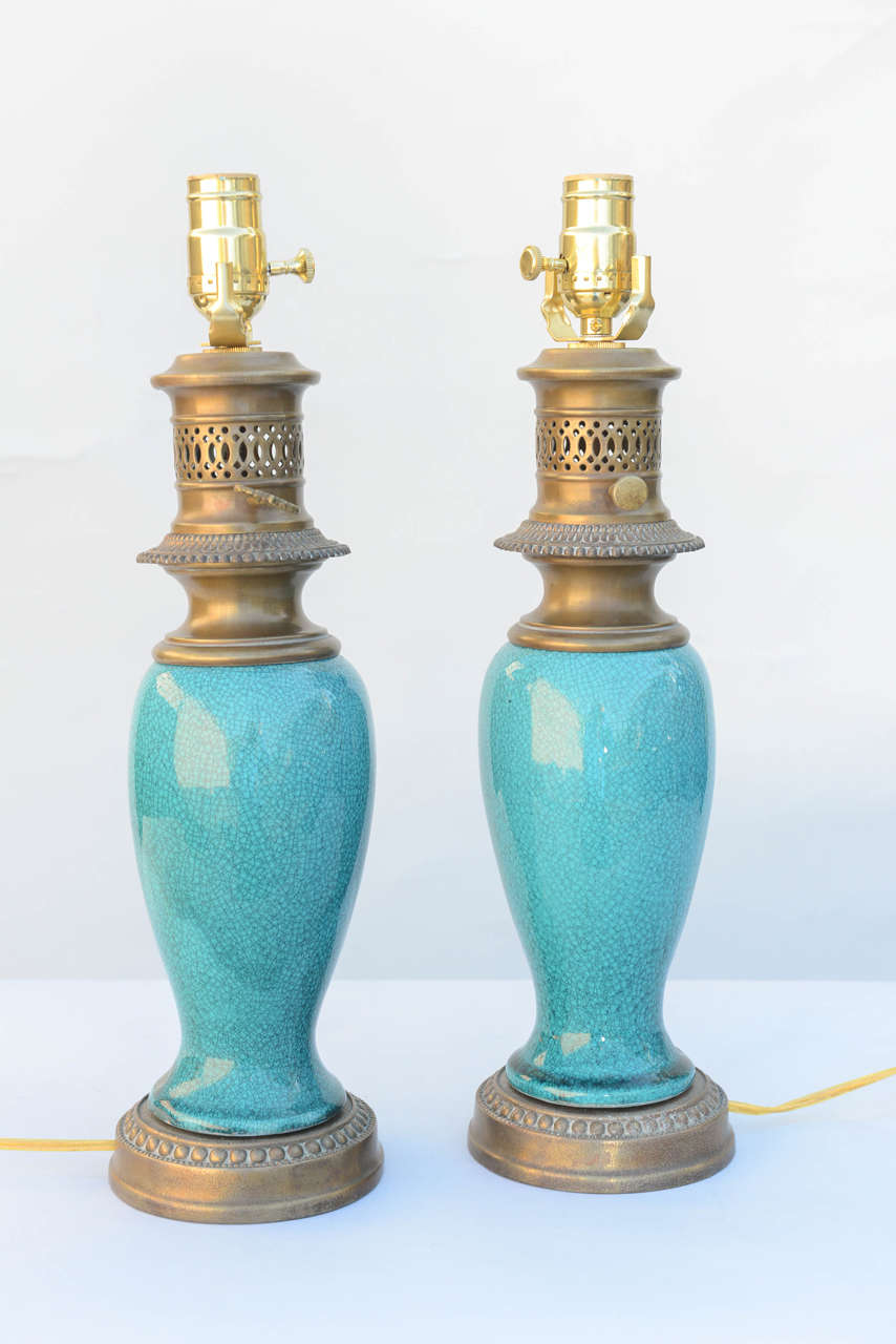 Pair of lamps, each a 19th Century Chinese vase, having a rich glaze of turquoise, lamped in the early 20th Century (originally oil burning), on gilded metal base and oil-lamp style cap.

Stock ID: D6839