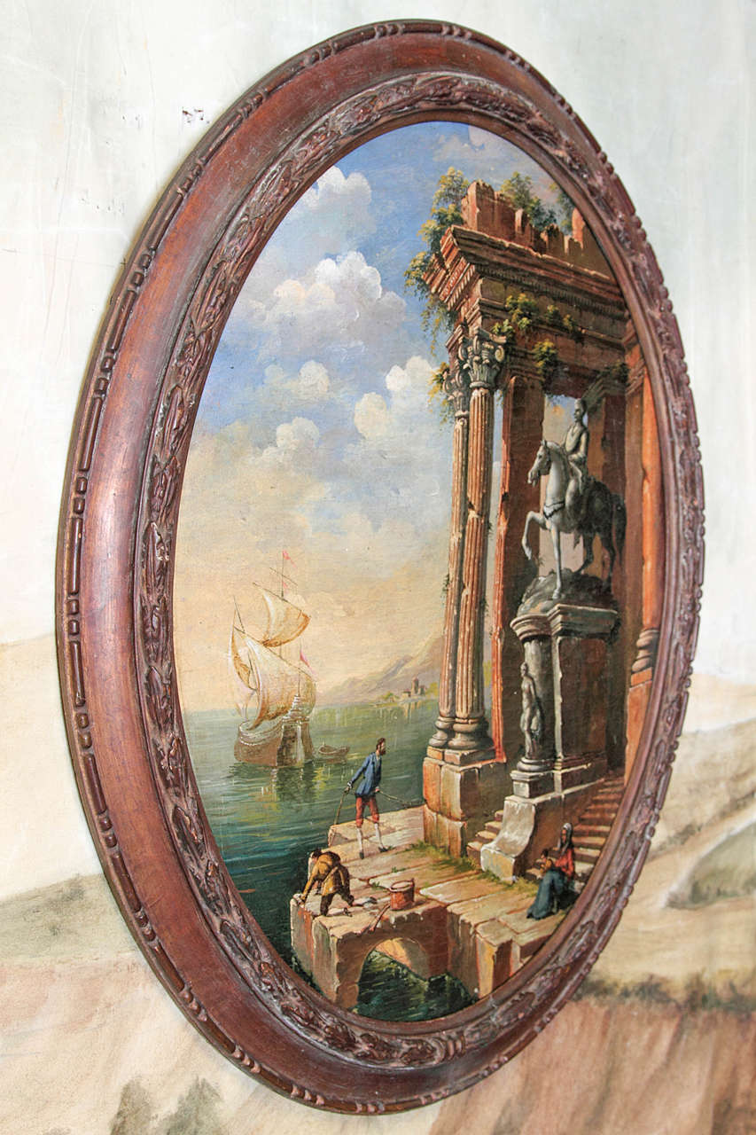 19th century Continental oil on canvas painting of classical architectural scene. In oval carved wood frame.