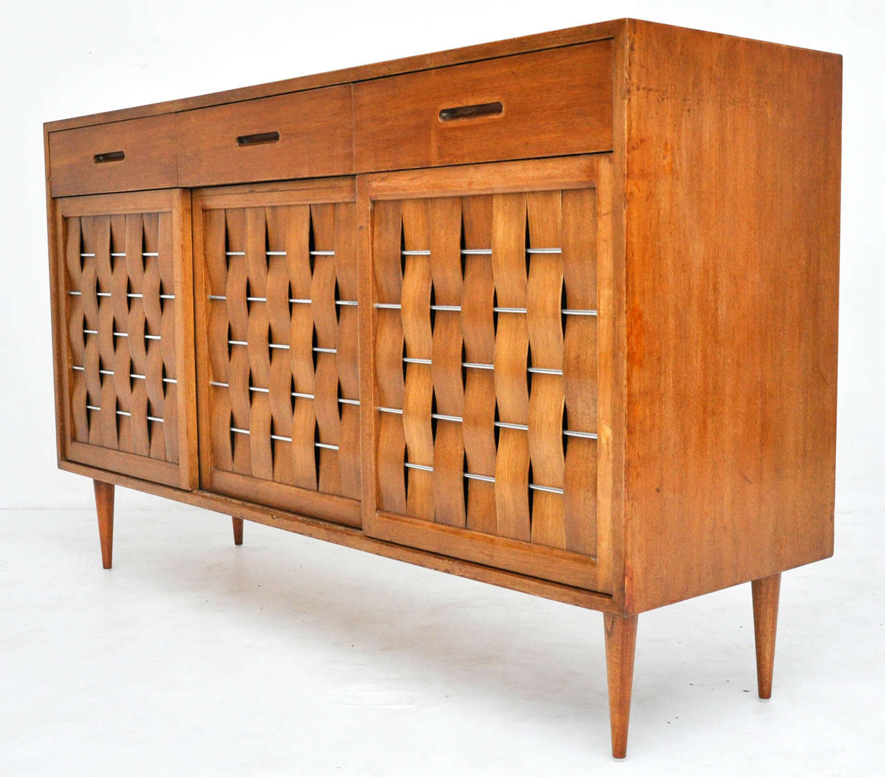 Woven-front cabinet by Edward Wormley for Dunbar. Three-door mahogany case with nickel details.