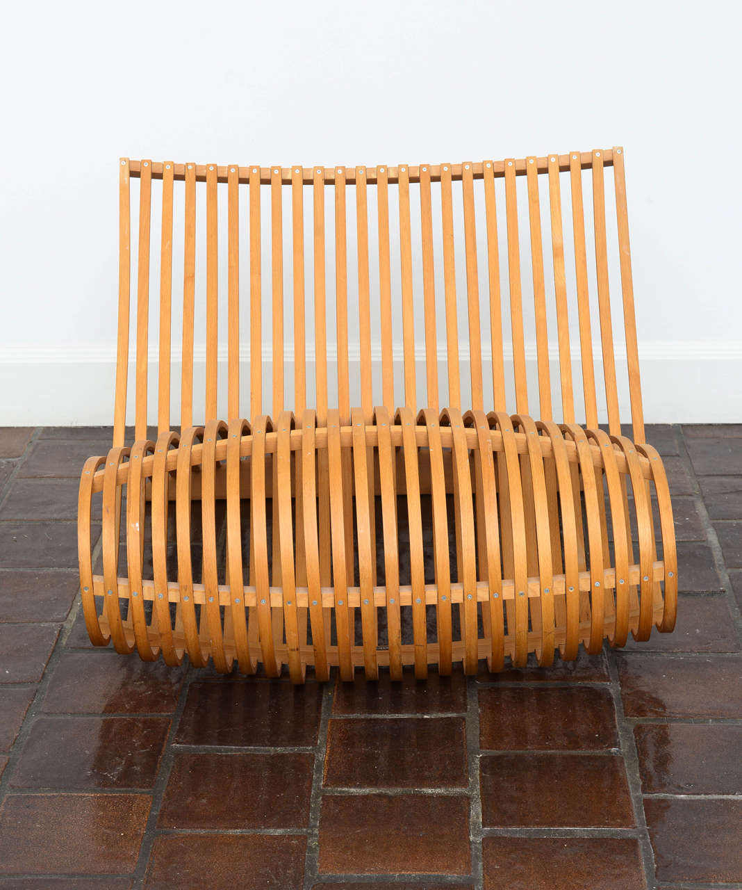 MN/30 chair designed by Marc Newson. 

Artistically designed slatted natural beachwood strips bent to form a double curve alpha shape, engineered for both beauty and function.