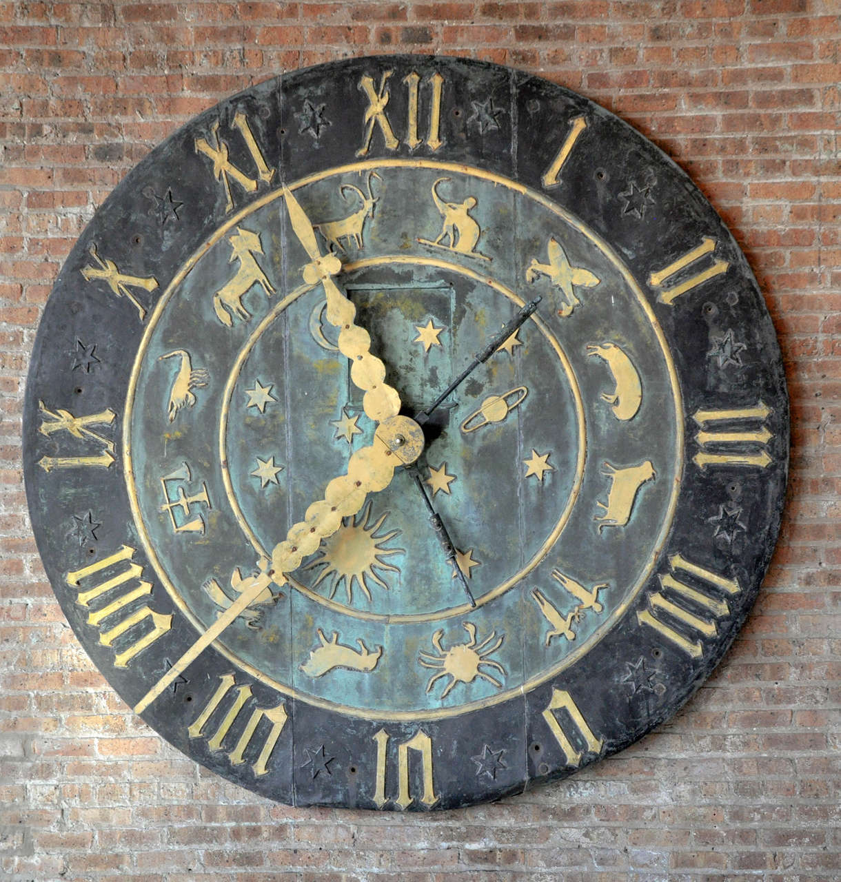 American zinc over wood clock face with Roman numerals and zodiac signs from the Schlitz Brewery clock tower in Milwaukee, Wisconsin.