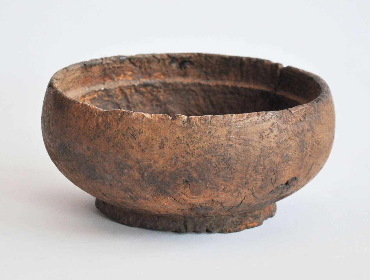 Early 19th Century Wooden Bowl From Nagaland
These beautiful primitive bowls were used in kitchens for various food oriented activities including storing and cooking. 
This example shows typical subtle carvings which verify its origin
Details have