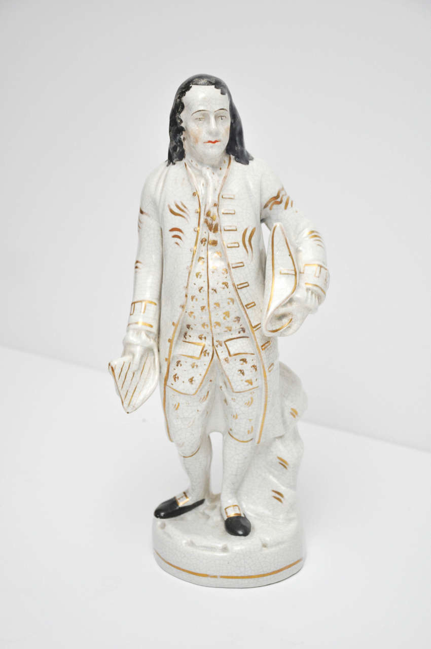 An authentic English Staffordshire pottery figure of the U.S. statesman, Ben Franklin holding his Tricorn Hat and Document. Poly Chrome and Gilt Decoration.