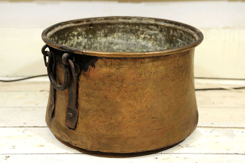 Solid Copper, heavy pot with strong Iron handles.