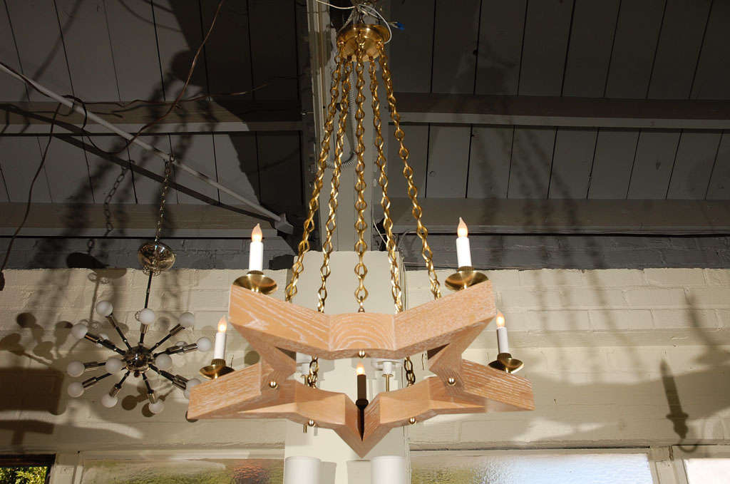 Paul Marra Star Chandelier shown in oak and brass. Two remaining by order. 