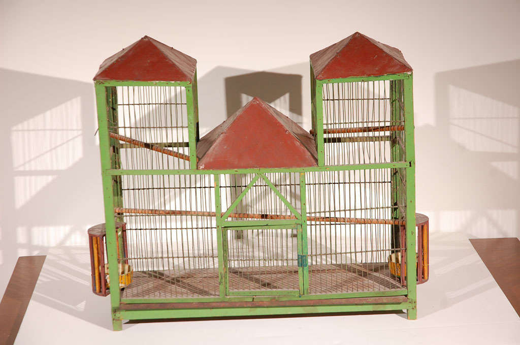 Enchanting rural wooden and metal Architectural Bird Cage with turnabout feeders and tin roofs. Painted apple green, sun flower yellow, and barn red.