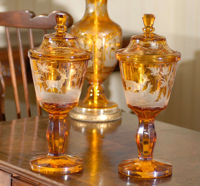Pair of beautiful antique amber bohemian cut glass vases with lids and deer/landscape motif