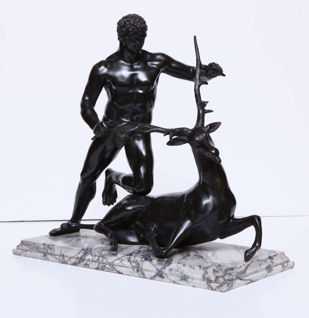 A 19th century Continental bronze of Hercules capturing the Ceryneian Hind
