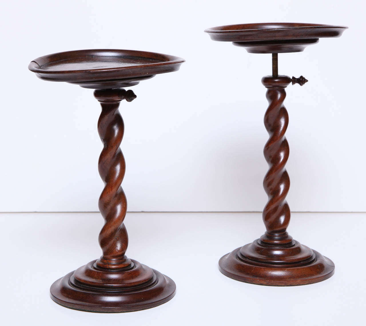 A rare pair of English William and Mary burr yew wood barley-twist adjustable candlestands.