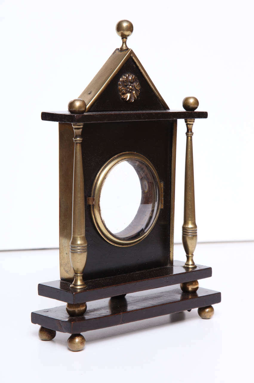 A 19th century English ebonized wood and brass pocket watch stand of architectural form, circa 1850