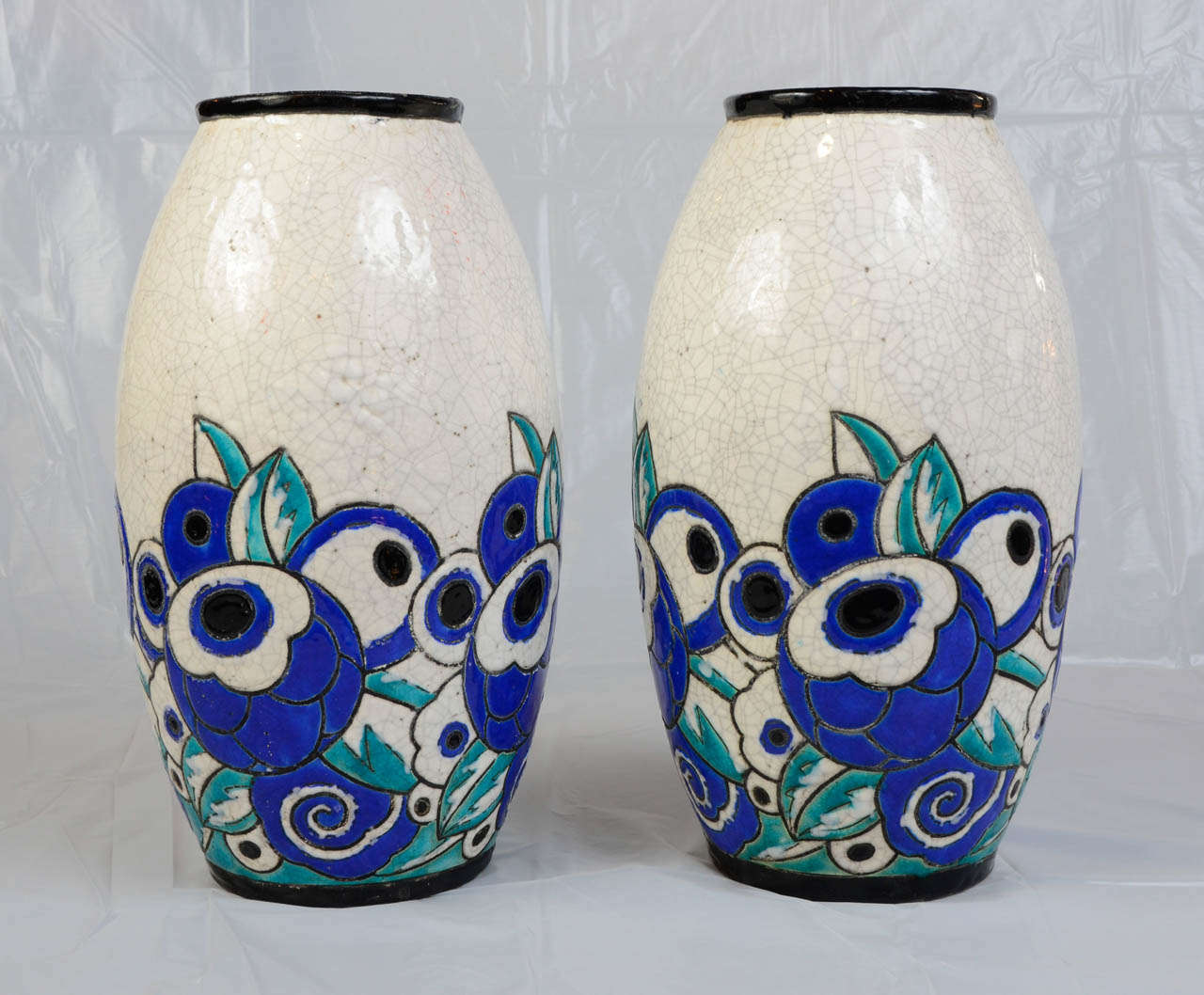 Pair of crackled ceramic vases with enameled flowers. Perfect condition. Signed and numbered. Attributed to Charles Catteau for Boch.