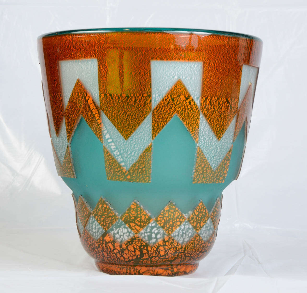 Large Art Deco vase in colored glass. Engraved and carved with gold insets. Orange, blue, grey and gold color. Attributed to Daum. Not signed. Marks seen on the photos are not cracks but lines on the glass mass.