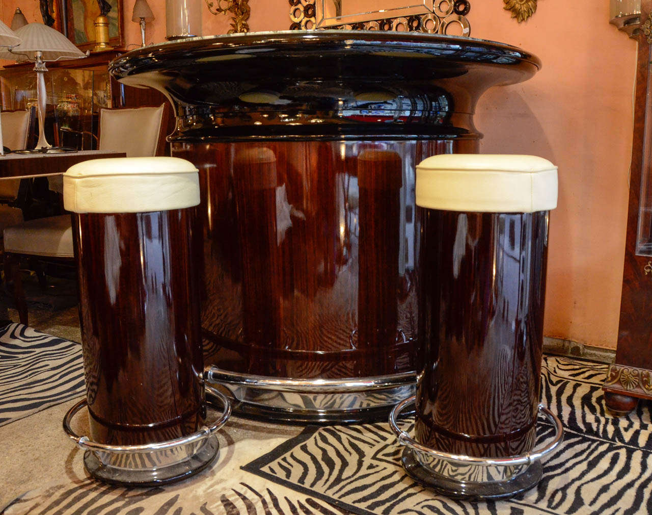 Large Art Deco style bar with a semi crescent design in Rio rosewood and black lacquer. Sea green veined marble top. Belt and foot rest in nickel plated chrome steel. Two bottle and glass crates inside. Two stools trimmed with ivory leather complete