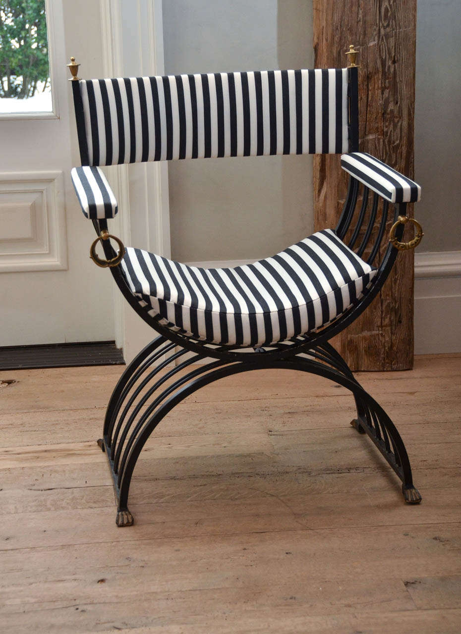 Pair of midcentury Roman inspired Savonarola chair in iron with brass finials and ornamentation. Newly re-upholstered in a black and white stripe.