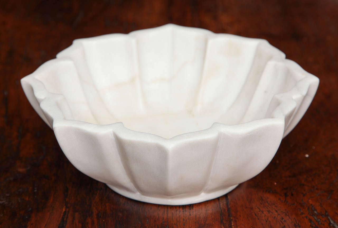 A carved white marble petal bowl from India.