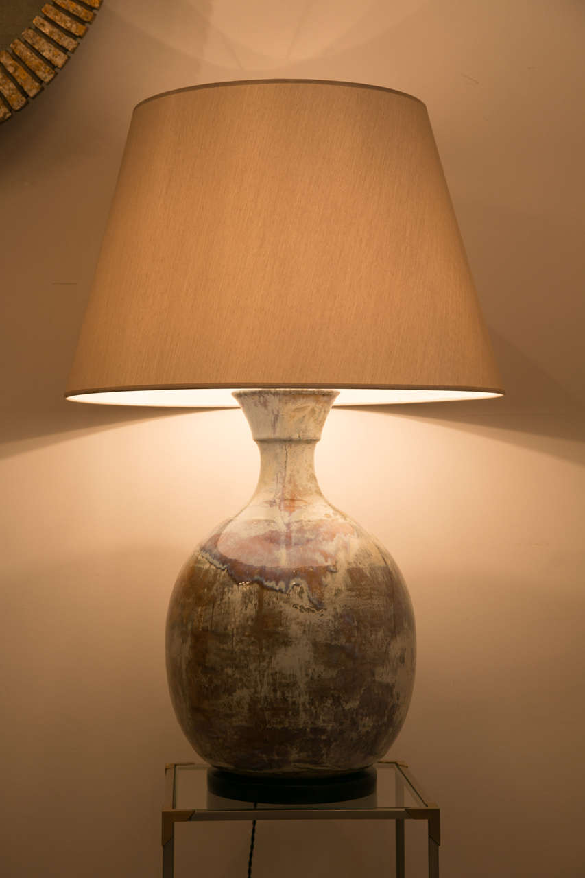 A large table lamp
Ceramic with a beautiful blue and beige glaze ,
mounted on a wooden base . 
France , Vallauris ,circa 1960. 

 Height of ceramic lamp : 54 cm
Overall height : 98 cm
 Custom made shade is included in the price .
